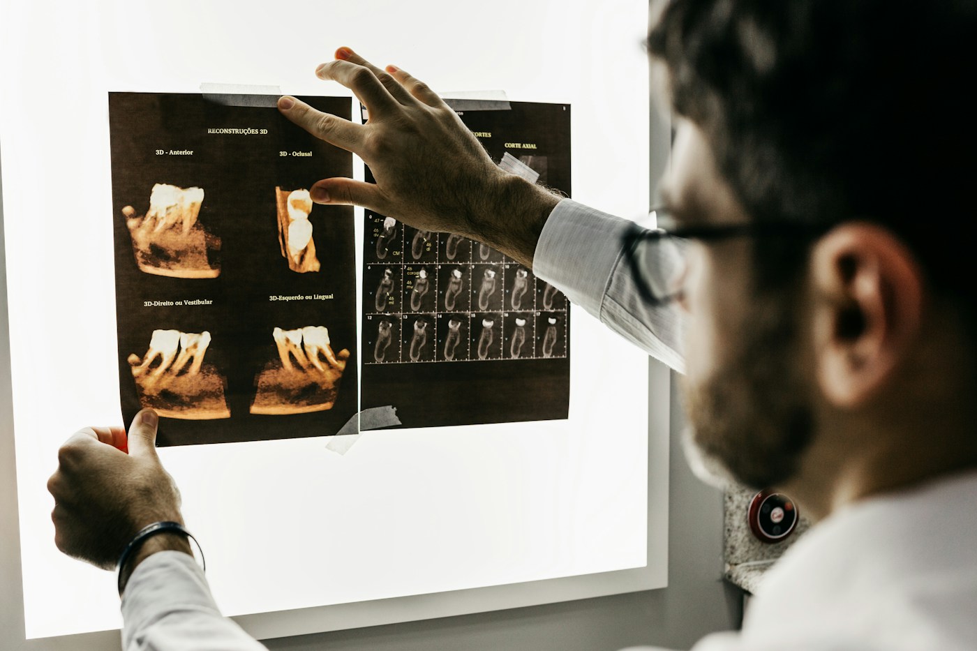 Stock photograph illustrating a dentist reviewing dental imaging